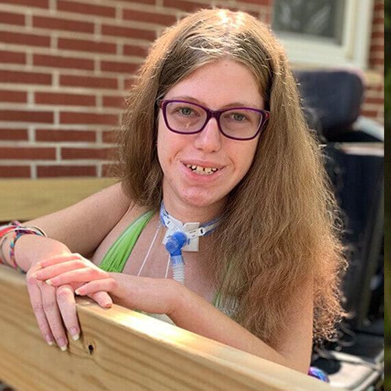 Image of Sarah smiling while on her deck